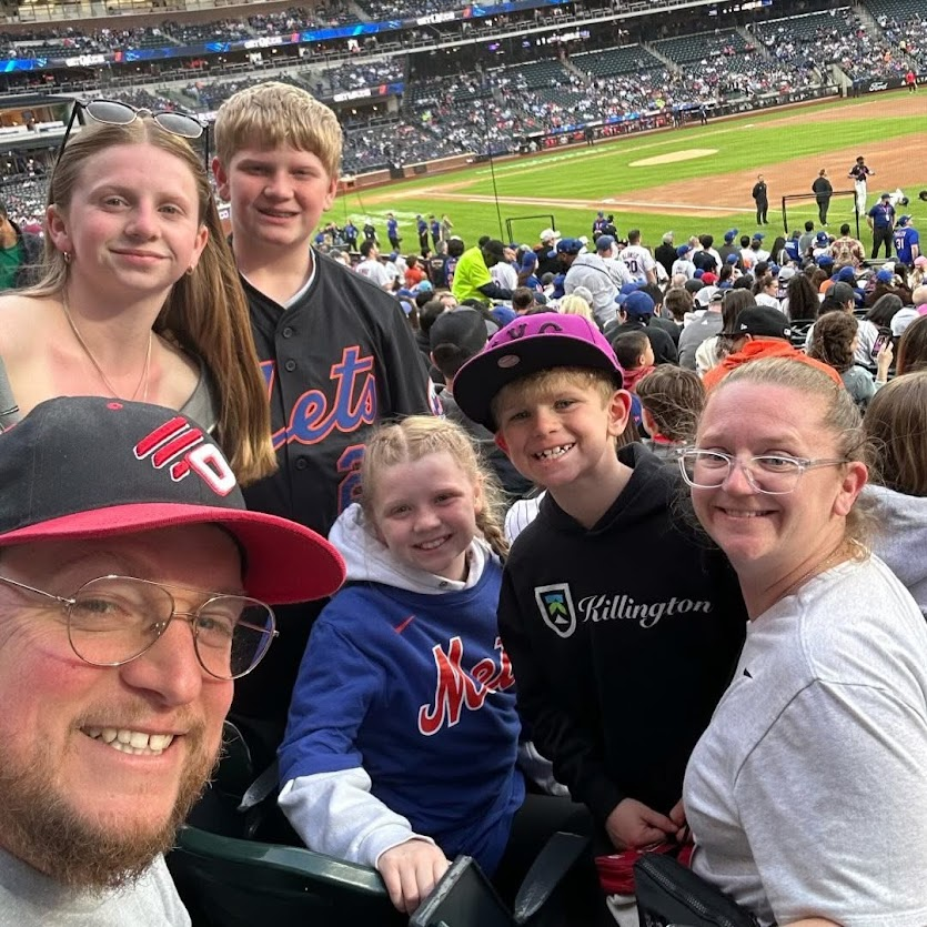 Kyle Graham with his wife and four kids at a baseball game
