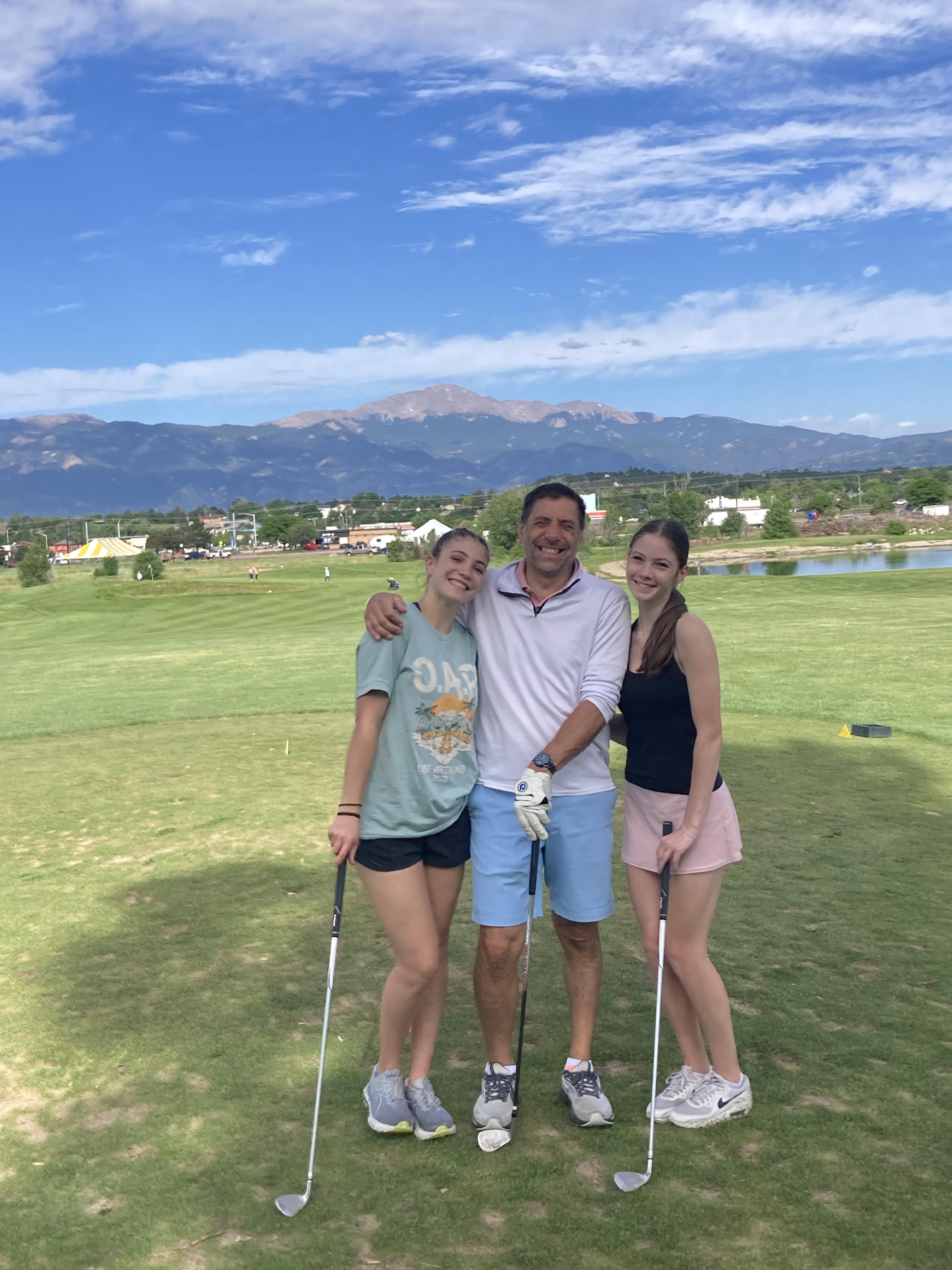 Dennis Paoloni golfing with two of his daughters