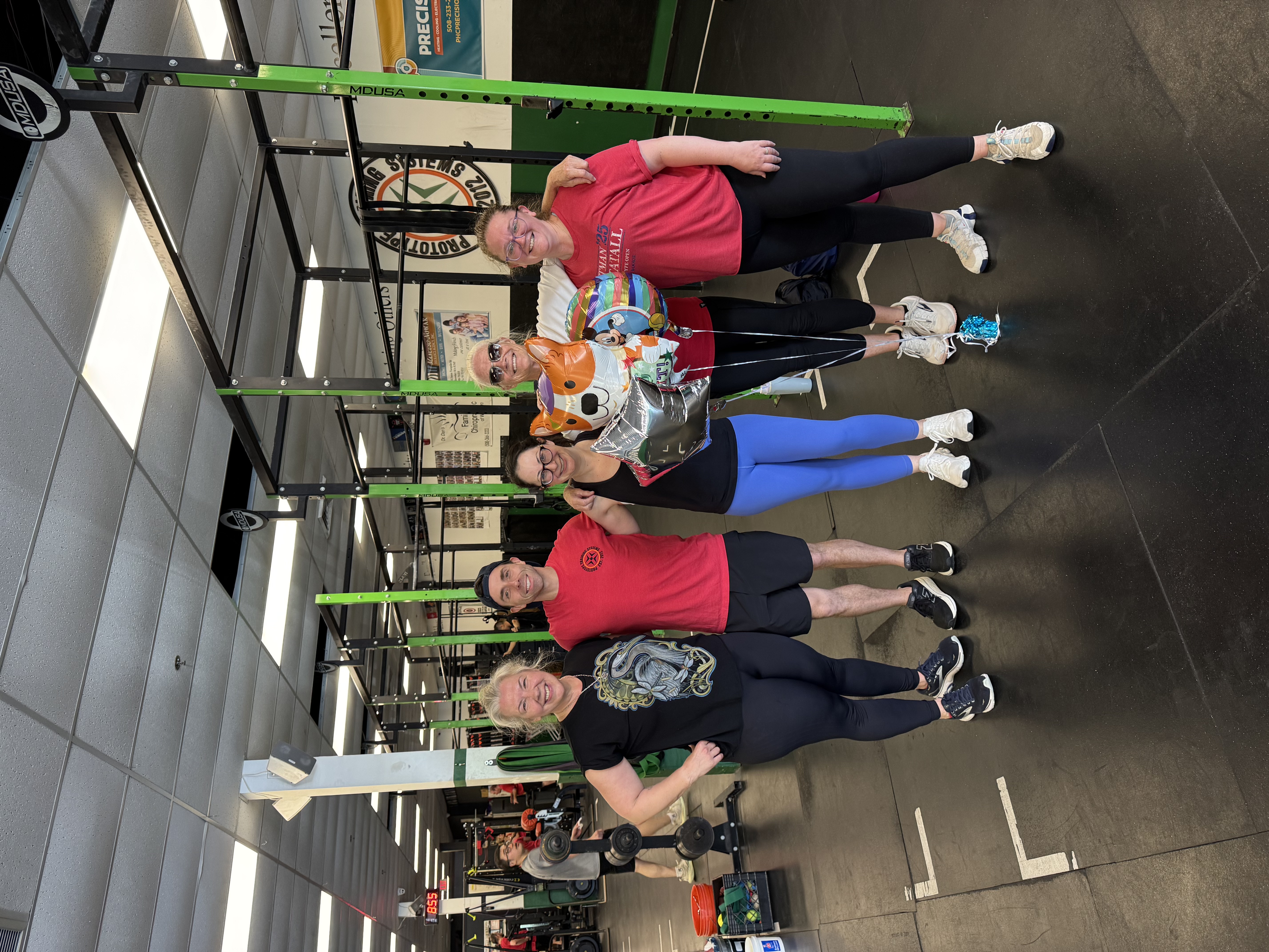 Shana Doiron's 9 a.m. class friends celebrating her 1,000th class with balloons