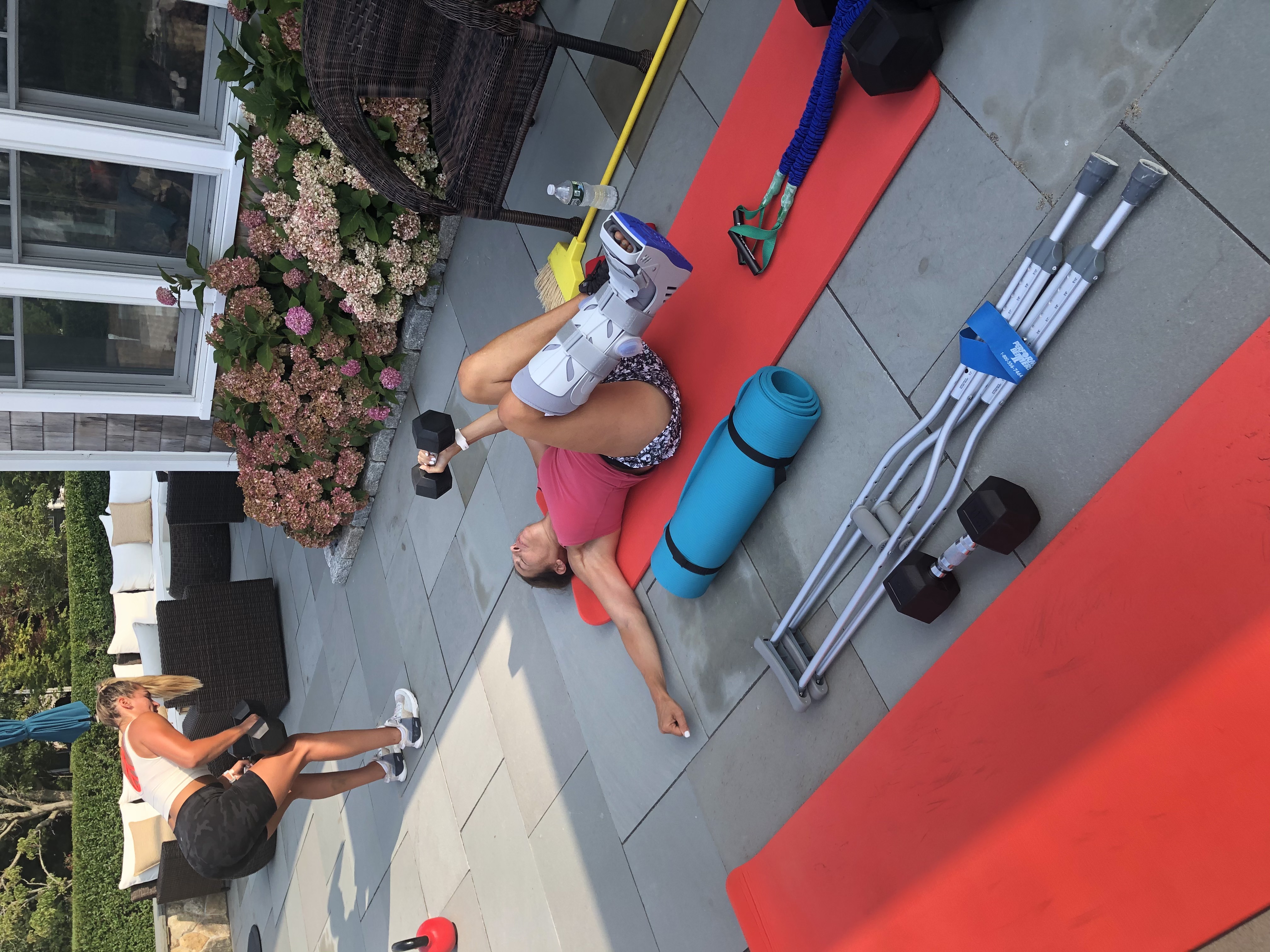 Sally Harwood working out the day after breaking her ankle, ankle boot on, crutches beside her