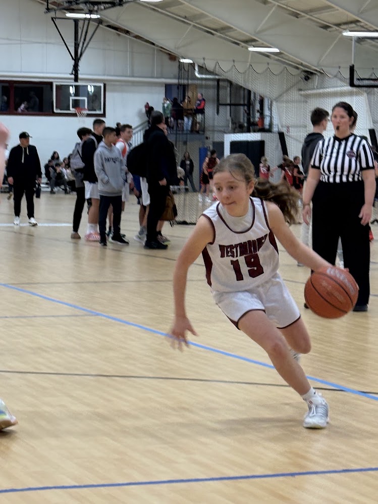 Josie Gualtieri driving to the basket during a youth basketball game