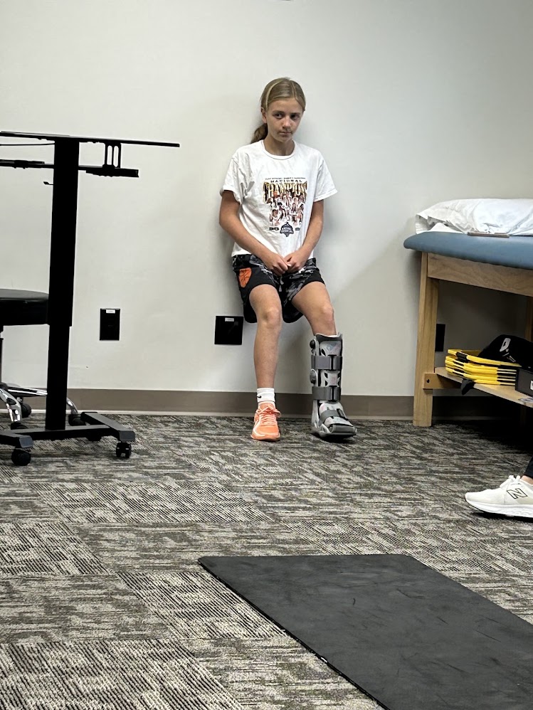 Josie Gualtieri in a walking boot while recovering from a tibial stress fracture