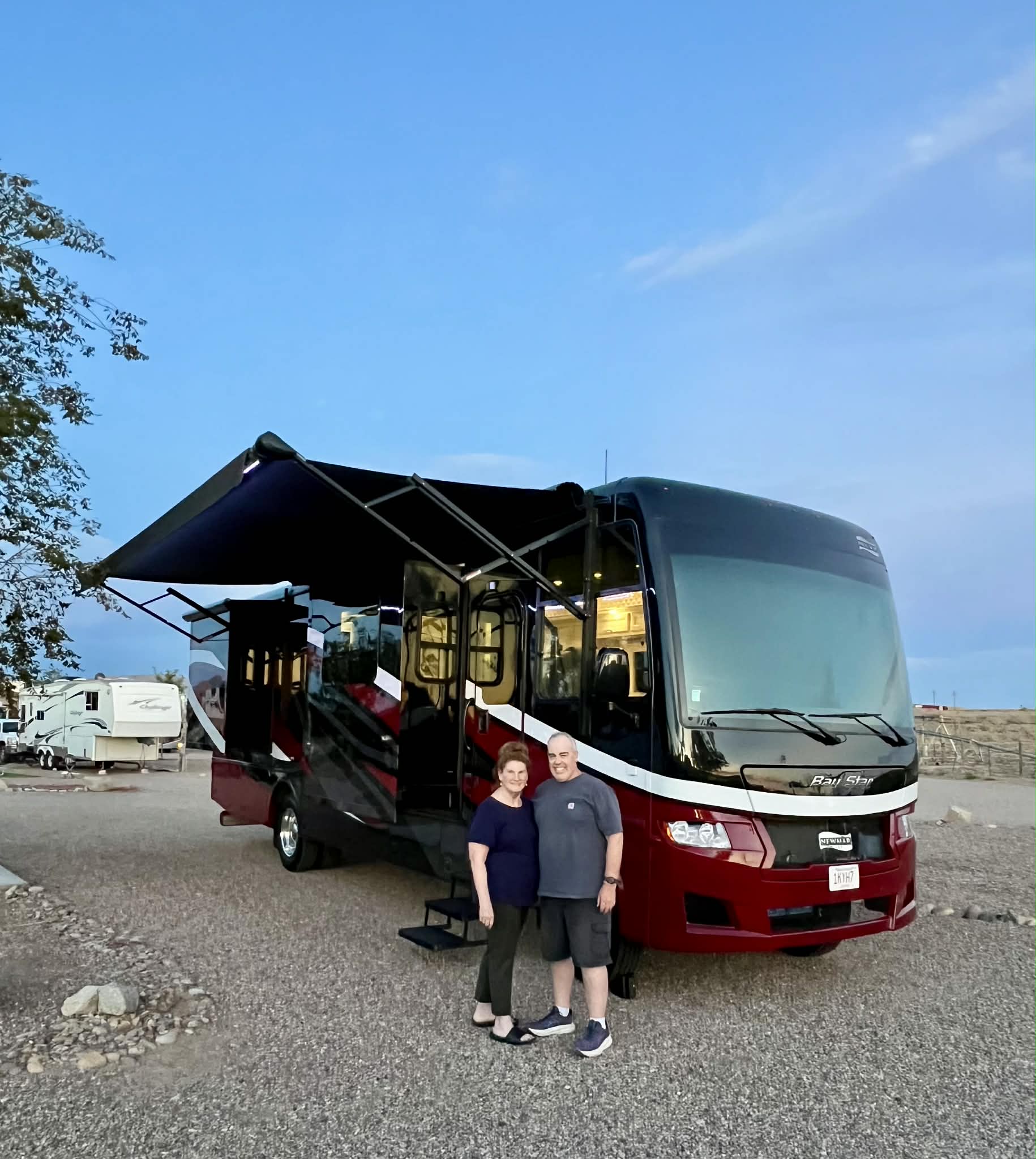 Sandie Hanlon and her husband Peter beside their motor home
