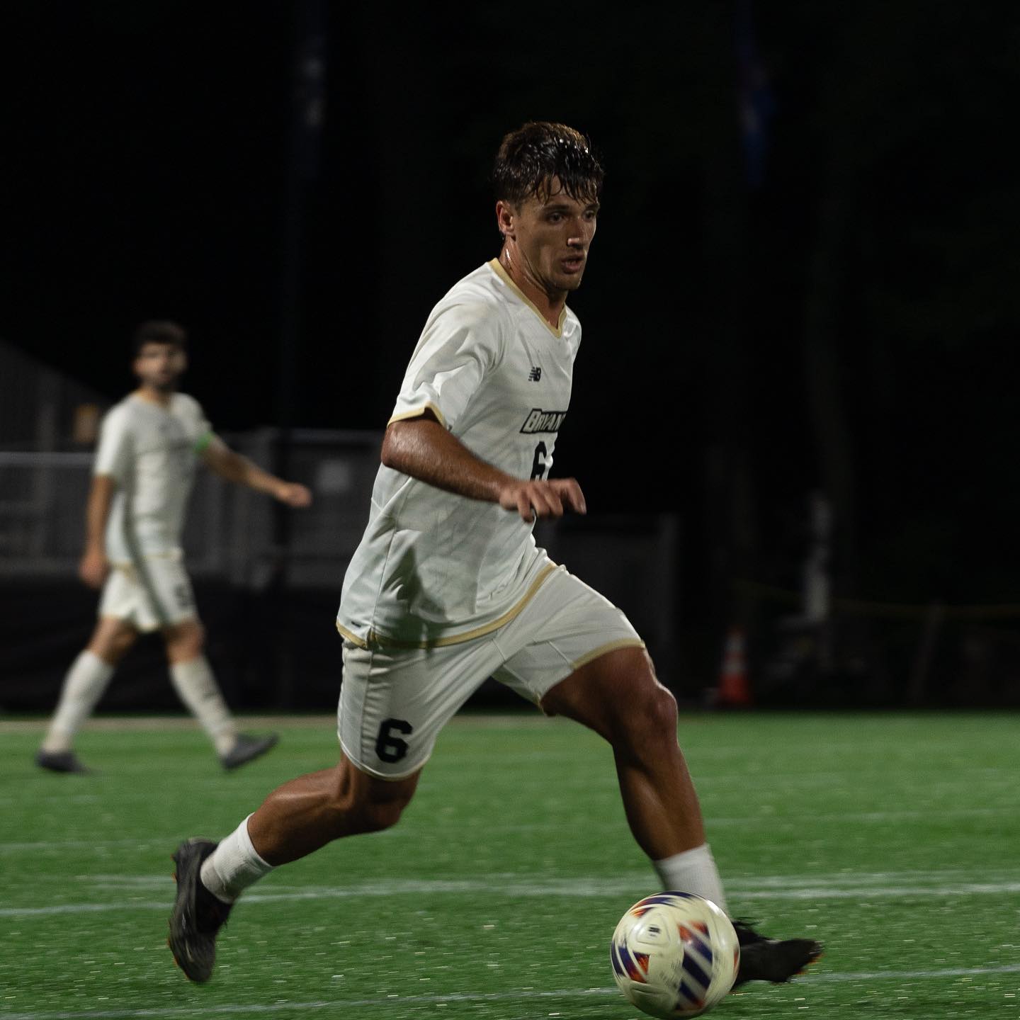 Santi driving upfield in a Bryant night match
