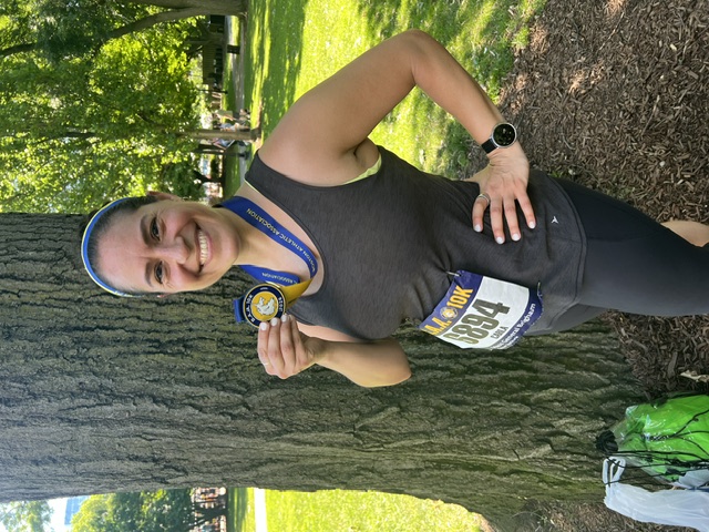 Carla Lopez holding a medal after a race