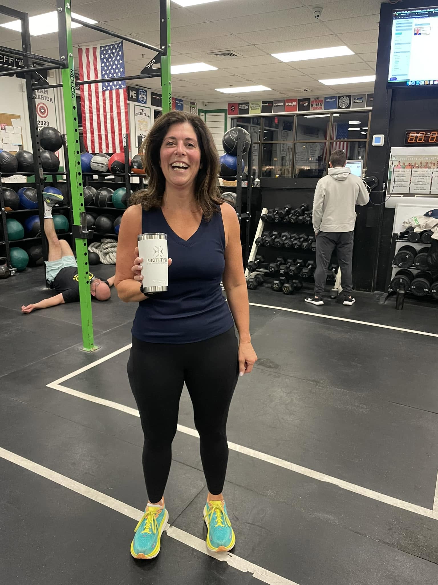 Heather Schmidt holding her Committed Club 1,000 sign-in Yeti
