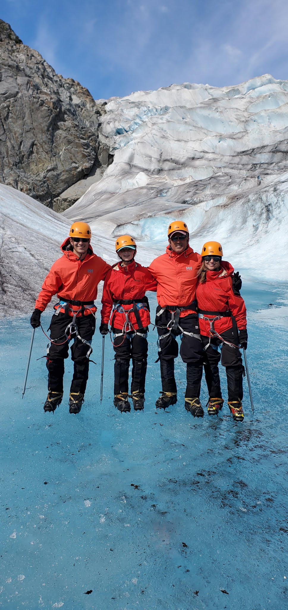 Eric Rogers and his family hiking on ice with crampons during a family vacation