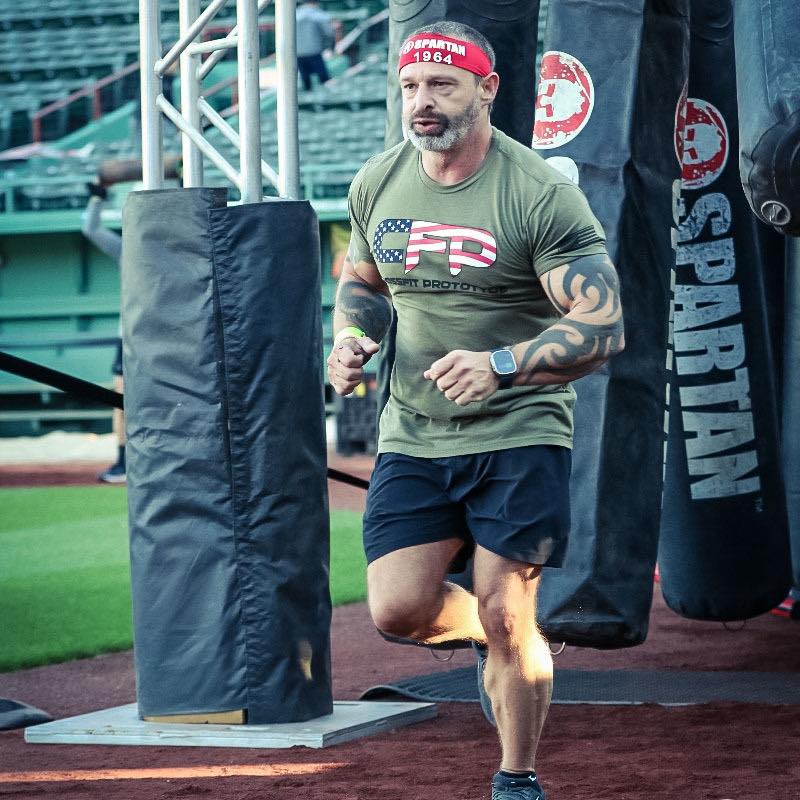 Tony Pittman running the Spartan Fenway race in his Prototype Training Systems shirt
