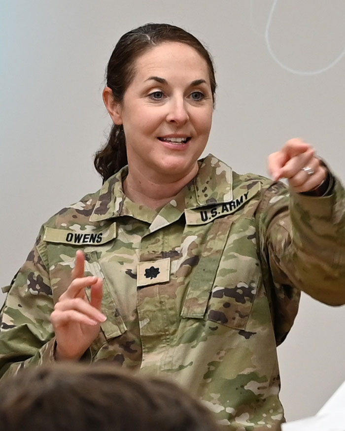 Bridget Owens in uniform giving a research presentation