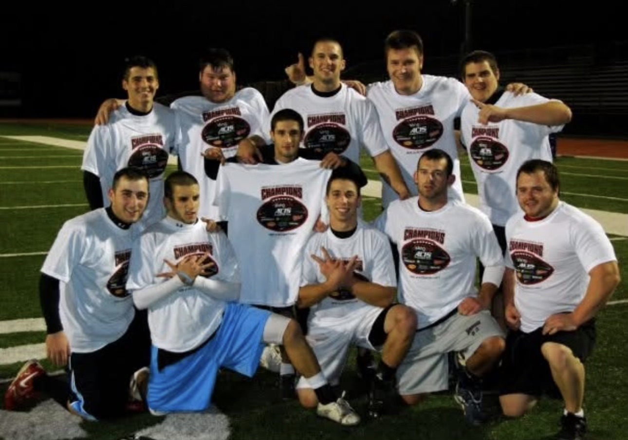 Mike Collette and Steve Cimino with one of their flag football championship teams