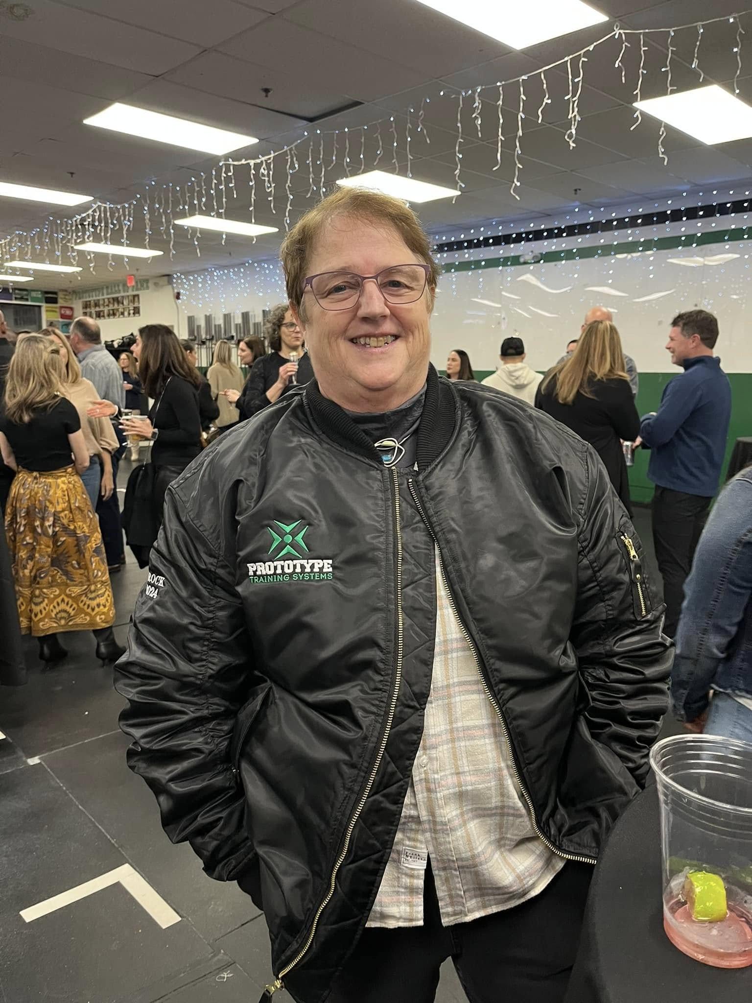 Sandy Brock wearing her Prototype Training Systems Hall of Fame jacket