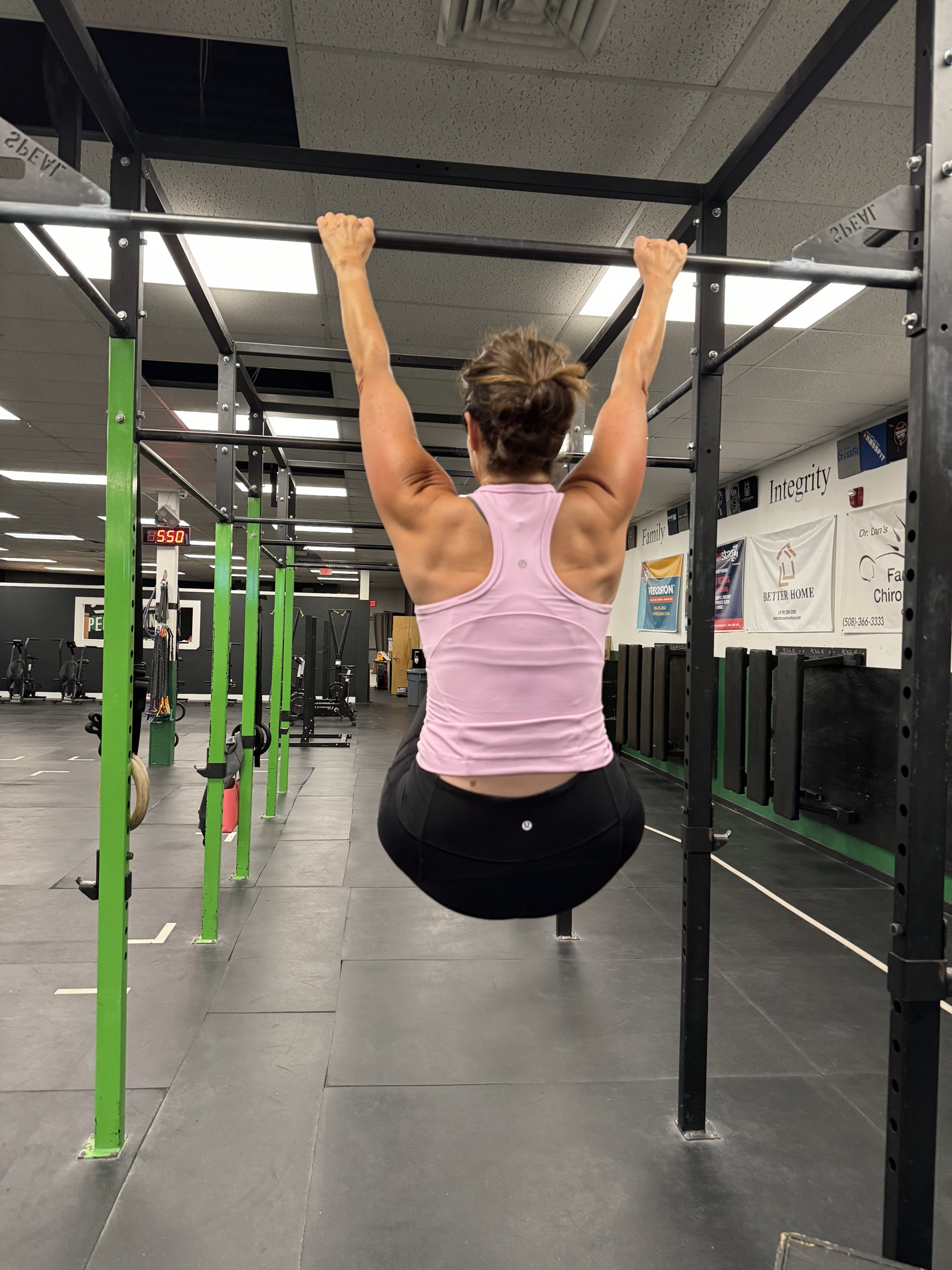 Heather Schmidt hanging from the pull-up bar during a workout