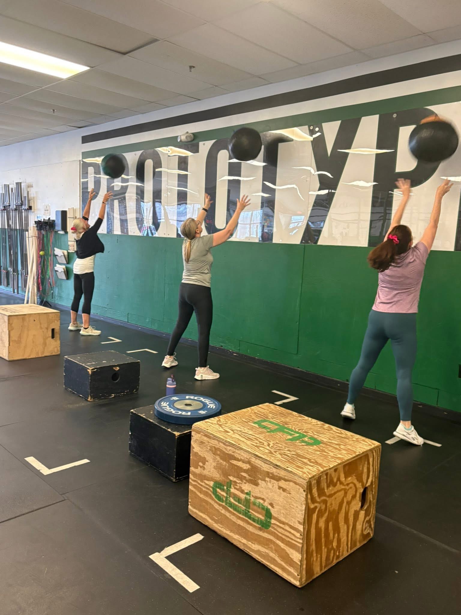 Lisa Scarlett doing wall ball shots at Prototype Training Systems