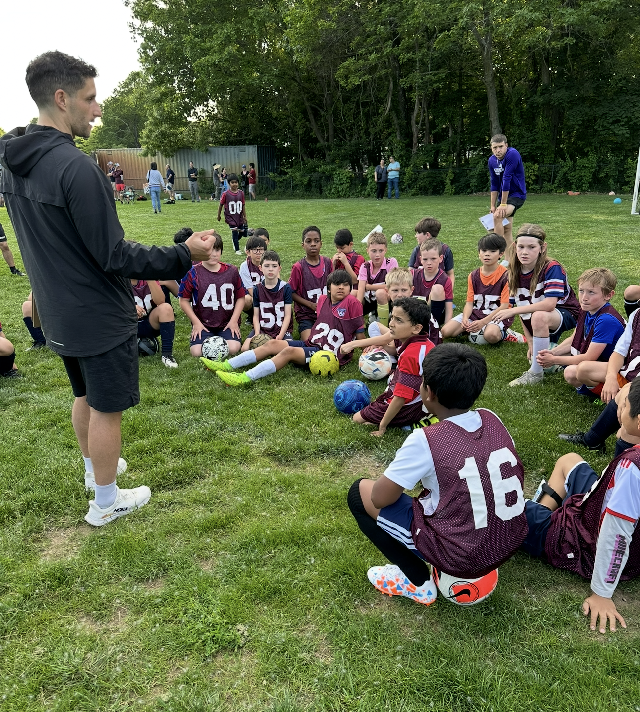 Steve Cimino talking with soccer players at tryouts