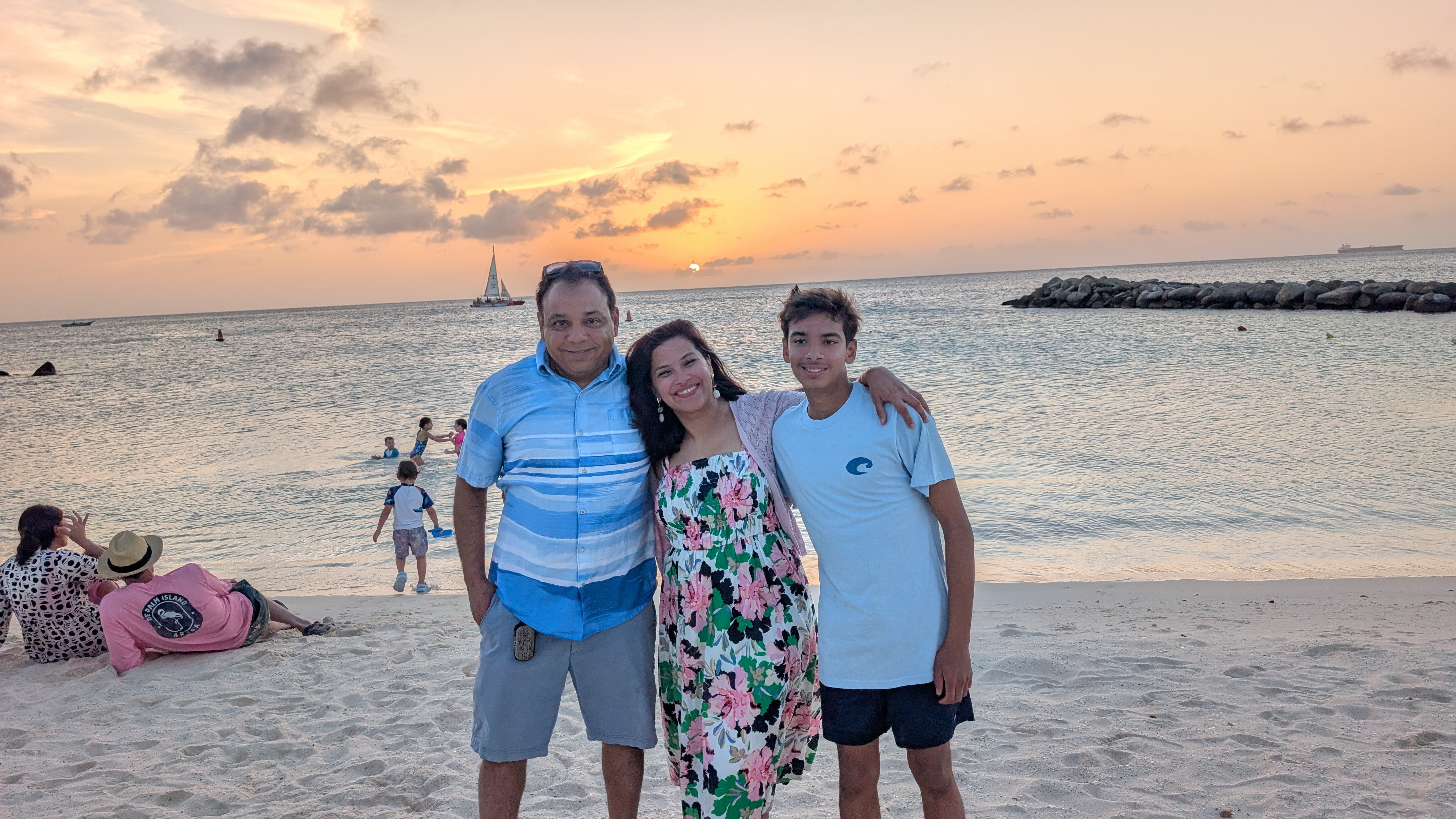 Gaurav Batra with his wife Shikha and son Vihaan on the beach at sunset