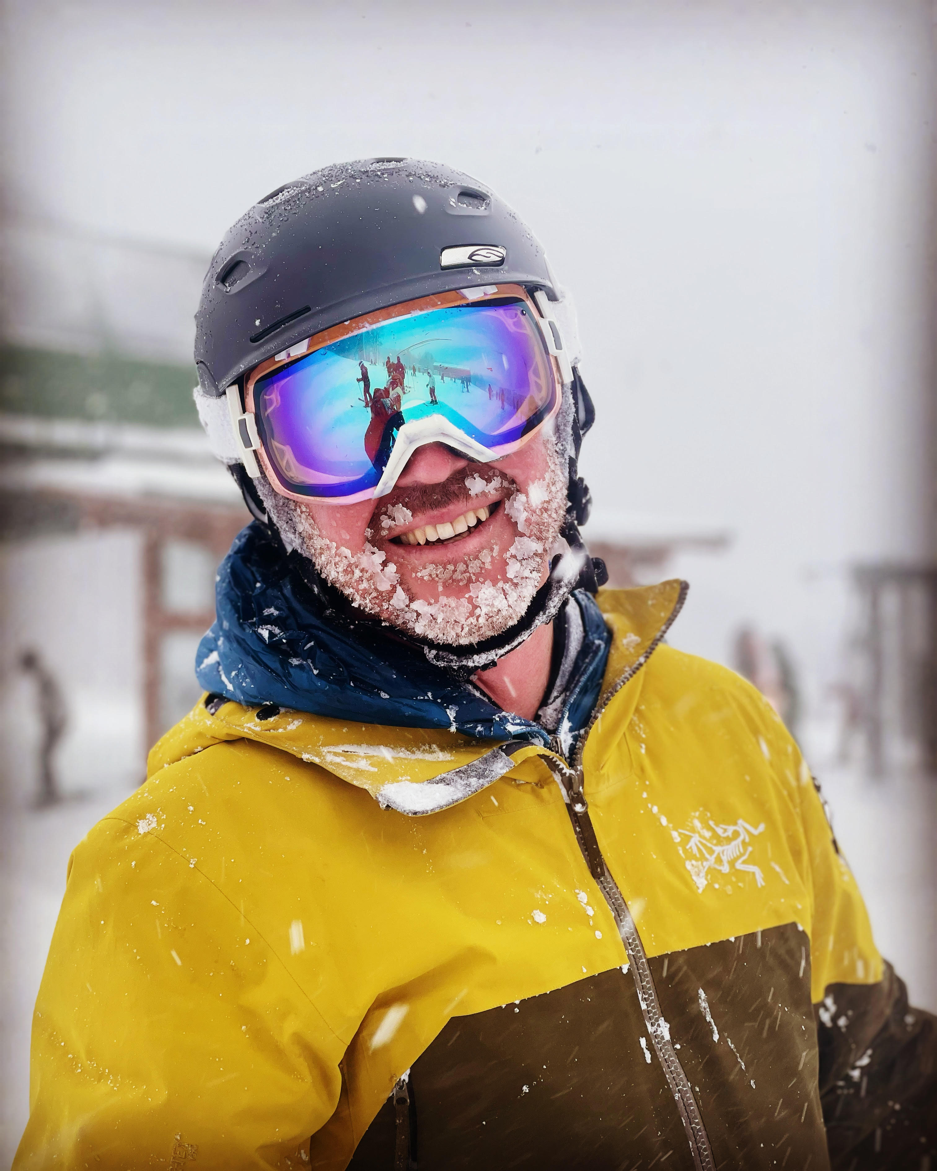 Alex Viox in snowboarding gear on the mountain, covered in snow