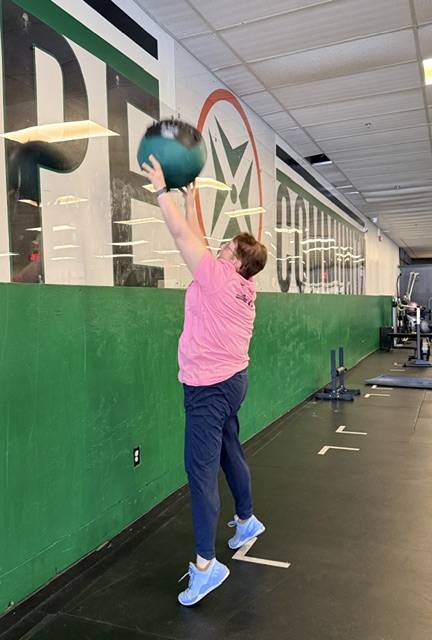 Sandy Brock throwing a wall ball shot during a class at Prototype Training Systems in Westborough, MA